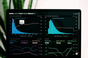 Modern Workspace with Laptop Showing Stock Market Data Analytics Dashboard