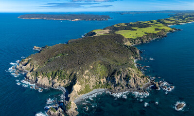Aerial view of the coastline in Tawharanui, New Zealand. The image shows the rugged coastline,...