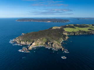 Aerial view of the scenic coastline of Tawharanui Peninsula, New Zealand. The image showcases the...