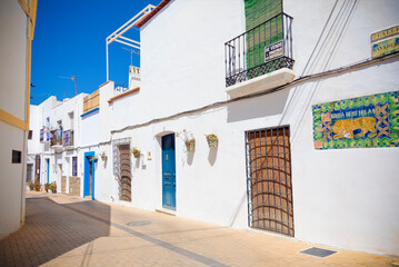 Charming and typical street in a white-washed Mediterranean town. Nijar, Almeria, Spain