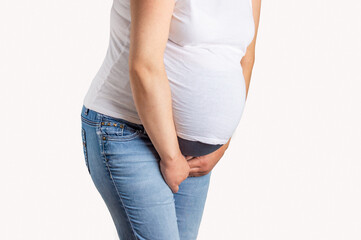 Profile view of a pregnant woman with urine due to incontinence and isolated on white background