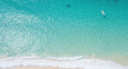 Aerial view of a pristine beach with turquoise water and white sand creating a tranquil and inviting coastal scene