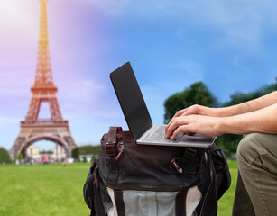 Shot of an unrecognizable digital nomad sitting alone and typing on his laptop during the day at Paris