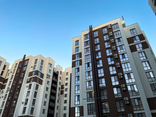 Modern residential buildings with large windows and air conditioning units