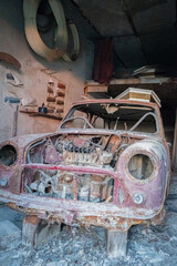 old mini cooper car abandoned in workshop in ghost town following earthquake - Apice - Italy