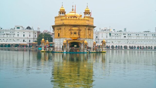 Golden Temple in Amritsar, India. Majestic Sikh gurdwara covered in gold, reflecting in the sacred water pond, a spiritual and cultural landmark.