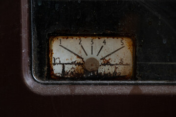 Old rusty dial gauge on gas oven in kitchen, close-up, vintage appliance, dirty panel