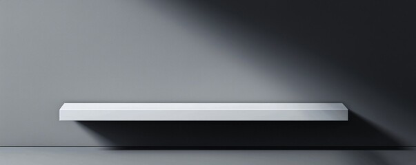 A clean and minimalist spooky abstract background with a simple, black shape. The solid, unlit form casts an unnerving, long shadow on a dark gray wall.