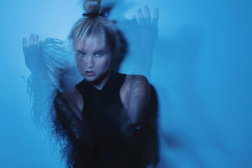 Creative Fashion Portrait of Woman in Blue Light with Motion Blur