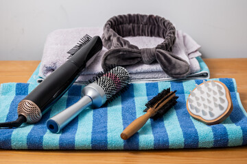 Hair brushes an tools on a towel - bend, brushes, hair straightener, massage