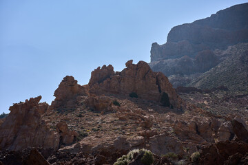Volcanic rock formations on arid slope