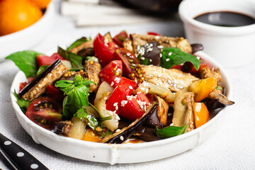Fresh Eggplant Salad with Tomatoes and Basil on White Plate