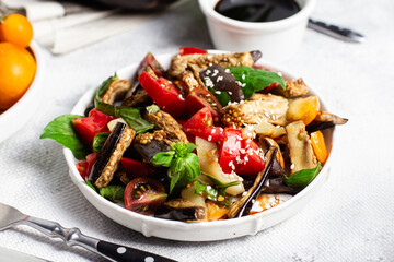 Fresh Eggplant Salad with Tomatoes and Basil on White Plate