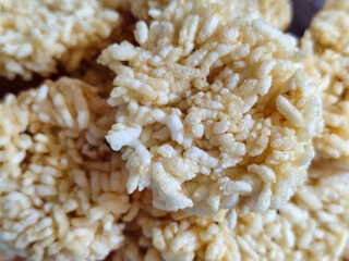 Stacks of rengginang, a traditional Indonesian snack made from fried sticky rice, display a crunchy...