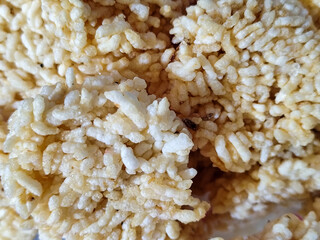 Stacks of rengginang, a traditional Indonesian snack made from fried sticky rice, display a crunchy...