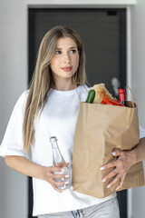 Woman with water and eco bag. Fresh groceries. Natural lifestyle