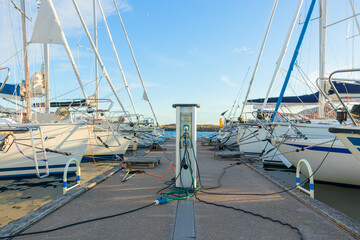 Charging station for boats at a marina pier in Finland, with electrical outlets where sailboats and...
