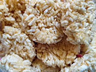 Stacks of rengginang, a traditional Indonesian snack made from fried sticky rice, display a crunchy...