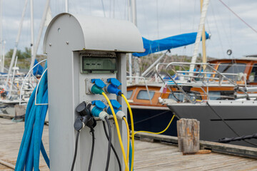 Charging station for boats at a marina pier in Finland, with electrical outlets where sailboats and...