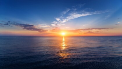 Obraz premium a serene sunset over a calm ocean evoking tranquility and natural beauty