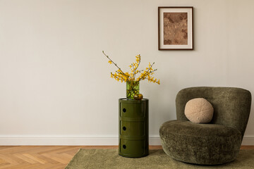 Minimalist corner od interior design with green armchair, graphic side table and yellow forsythia...