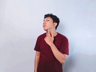 Man in red shirt making throat cut gesture. Concept of death, failure, or end. Isolated on white...