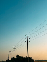 Silhouettes of Power Lines at Sunset with a Gradient Sky