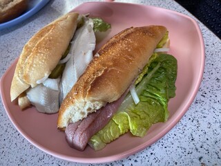 Fischbrötchen Matjes, Brötchen  Heringsbrötchen sandwich on a plate