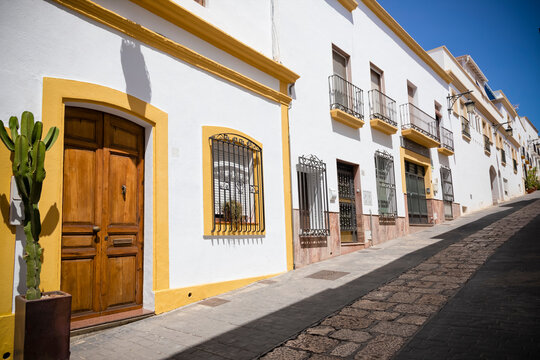 Typical street in Nijar, Almeria. Spanish street scene with white buildings and cobblestone path