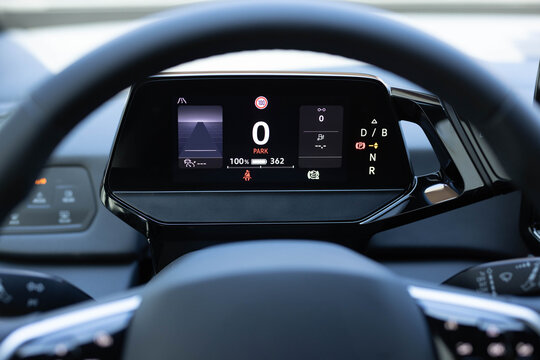 Electric car dashboard view when parked at power charging station. Zero emission car. Long range electric vehicle. Future of cars. Many different car dashboard lights with warning lamps illuminated