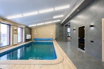 modern indoor pool area featuring a rectangular pool, wood and tile accents, bright overhead...
