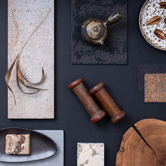 Creative flat lay composition with textile and paint samples, panels and cement tiles. Stylish interior designer moodboard. Navy, gray and brown color palette. Copy space. Template.