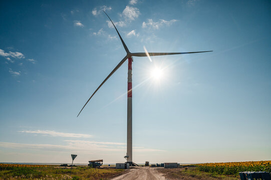 wind turbines in the wind park under construction in the Samara region in the sunflower field - Powered by Adobe