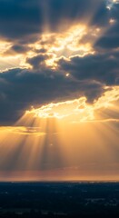 Obraz premium Golden sunlight piercing through a cloudy sky.