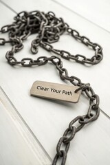Fototapeta premium Inspirational Metal Chain with Tag That Says Clear Your Path