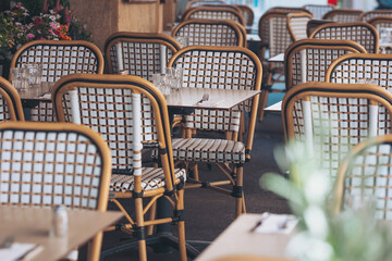 Charming dining area with woven chairs and rustic ambiance in a cozy restaurant during daytime service