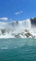 Cascading mist dances over sunlit rocks, evoking Earth Day's celebration of natural wonder and tranquil aqueous harmony