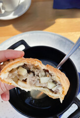 A savory hand pie cradles tender morsels at Oktoberfest brunch, an unexpected twist for culinary explorers, heritage Bavarian flavors