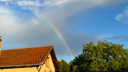 Rustic rooftop serenades vibrant rainbow, whispering folklore of Leprechauns' treasure hues,...