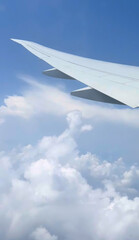 Jet wing slicing azure sky, dreamlike voyage above cotton candy clouds, invoking International Civil Aviation Day wanderlust