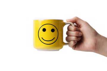 Hand holding a yellow mug with a smiley face.