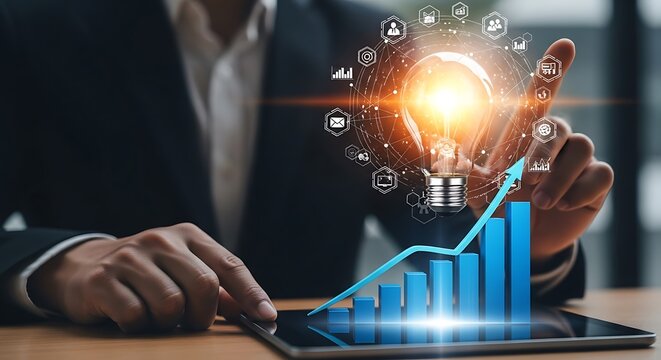 Businessman interacting with a digital tablet displaying a rising bar chart and a glowing light bulb surrounded by business icons