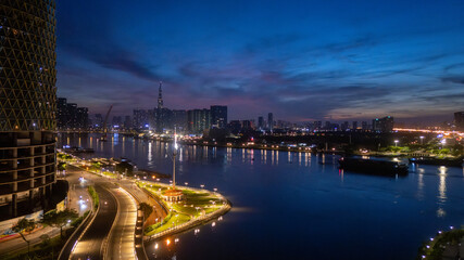 Fototapeta premium Aerial view of early morning in Ho Chi Minh City, Vietnam with development buildings, transportation, energy power infrastructure. Financial and business centers