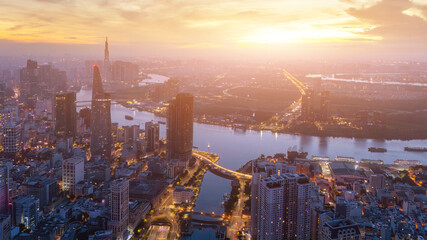 Naklejka premium Aerial view of early morning in Ho Chi Minh City, Vietnam with development buildings, transportation, energy power infrastructure. Financial and business centers