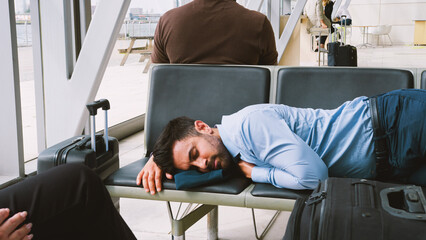 Businessman Sleeping On Seats In Airport Departure Lounge Because Of Delay