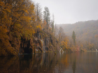 Plitvice Lakes in Croatia during autumn, showcasing stunning waterfalls, vibrant foliage, and crystal-clear waters, creating a magical and serene natural landscape perfect for nature lovers.
