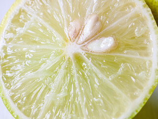 Macro of Halved lemon or lime fruit, close-up of slices lemon