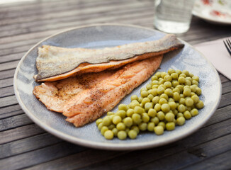 Delicious baked trout fillets with green peas