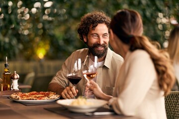 Couple Enjoying Dining and Conversation at an Elegant Outdoor Restaurant Setting