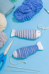 Handmade marine background. Crocheted sardine fishes, nautical style, traditional sea decor